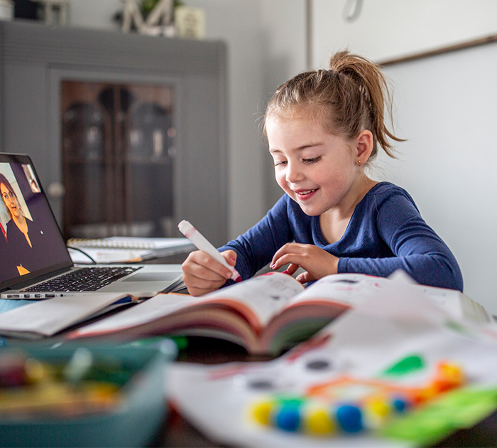 A four-year-old student engaging in an online school activity