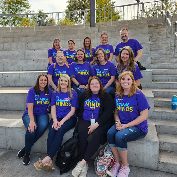 A group of Minnesota Connections Academy staff sitting together on steps at a field trip