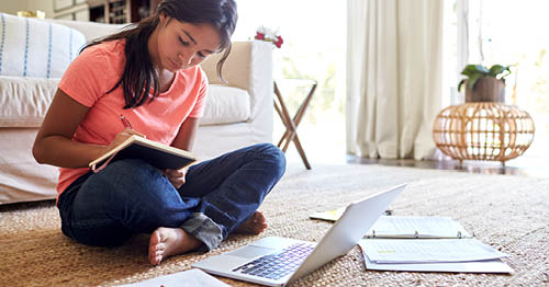 An online school student studying before going back to school. 